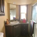 Bathroom vanity and mirrors in the Platinum Cottages model 561SL at Recreational Resort Cottages and Cabins in Rockwall, Texas