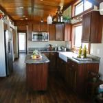 Austin model 588 kitchen featuring stained pine ceiling on display at Recreational Resort Cottages and Cabins in Rockwall Texas