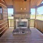 Exterior fireplace on RV park model porch on display at Recreational Resort Cottages in Rockwall, Texas