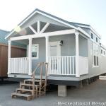 RV Park Model Platinum Premier tiny house with grey exterior on display at Recreational Resort Cottages and Cabins in Rockwall, Texas