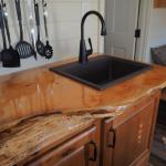 Custom treetrunk countertops are available in Cavco Cabinettes for sale at Recreational Resort Cottages and Cabins in Rockwall, Texas