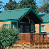 Creekside Cabin with Green Metal Roof and Green Trim